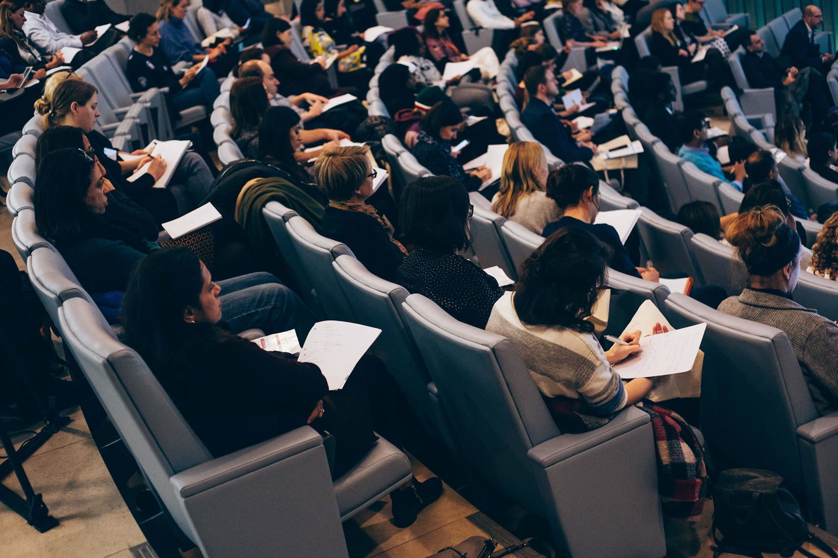 Delegates listening and taking notes during King's Paediatric Conference
